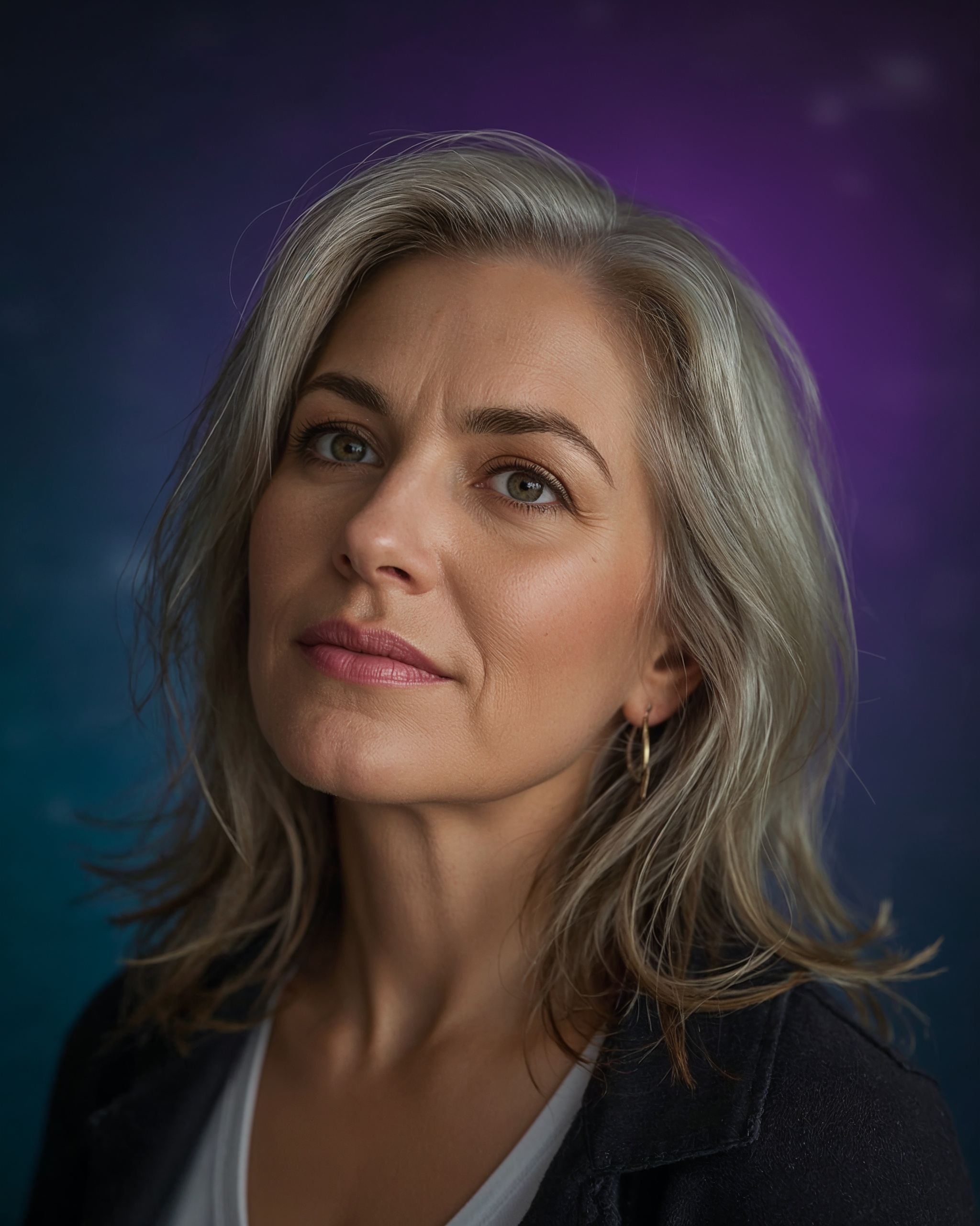 A woman looking calmly upward toward the light